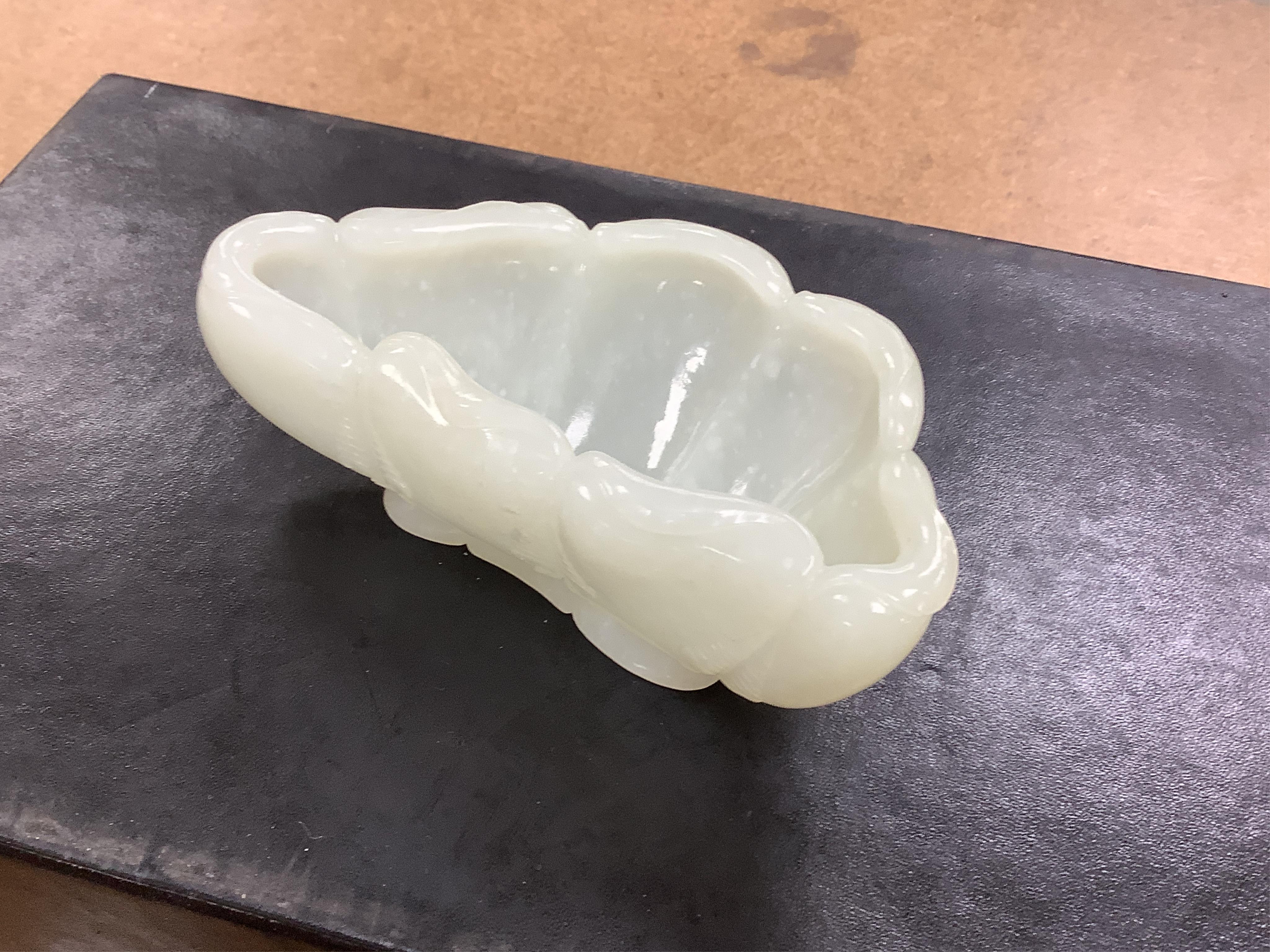 A Chinese jade ‘lotus’ shaped brush washer, 13cm wide. Condition - good